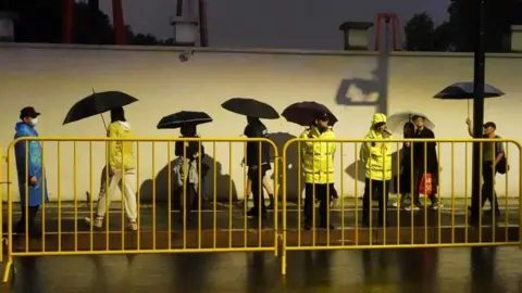 Reuters Police keep watch near barricades set up along a road in Shanghai during Halloween week