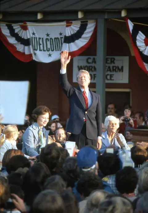 Corbis/Getty Images Newly elected President Jimmy Carter with his wife and mother salutes the crowd of supporters at a victory rally in his home town of Plains Georgia 