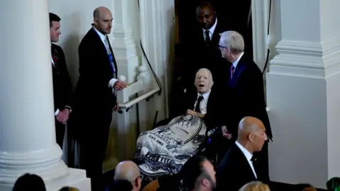 Getty Images President Carter entering his wife's funeral service service 