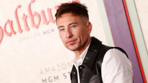 Getty Images The actor Barry Keoghan at the premiere of Saltburn. He has short brown hair and is wearing a black waistcoat and white shirt.