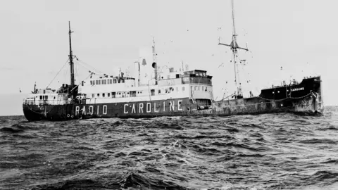 Getty Images Black and white photo of the Radio Caroline ship at sea