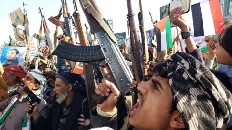 EPA Armed Houthi supporters take part in a protest against Israel and the US in Sanaa, Yemen (27 December 2024)