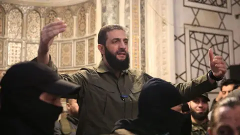 AFP Hayat Tahrir al-Sham (HTS) leader Abu Mohammed al-Jawlani speaks to a crowd at the Umayyad Mosque in Damascus, Syria, after the overthrow of President Bashar al-Assad (8 December 2024)