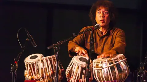 Getty Images CHARLES LLOYD on saxophone, ZAKIR HUSSAIN on tablas and ERIC HARLAND on drums preform as SANGAM at the MONTEREY JAZZ FESTIVAL (Photo by Craig Lovel