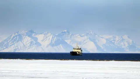 Getty Images A ship off the coast of Norway's Svalbard island, high above the Arctic Circle