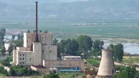 Kyodo North Korea's Yongbyon nuclear plant is seen before a cooling tower (R) is demolished, in this photo taken June 27, 2008 and released by Kyodo.