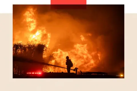 Getty Images A firefighter attempts to tackle a blaze