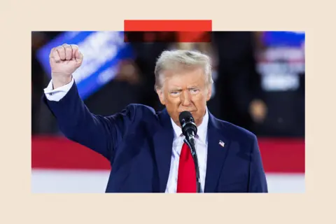 Getty Images Donald Trump raises his fist as he speaks during a campaign rally