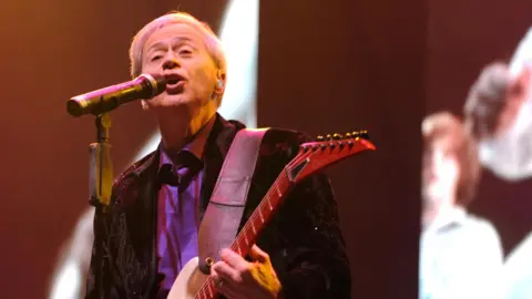 Getty Images Wayne Osmond plays guitar